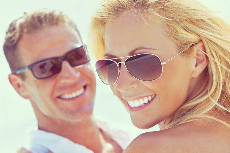 Happy couple in the sun with sunglasses