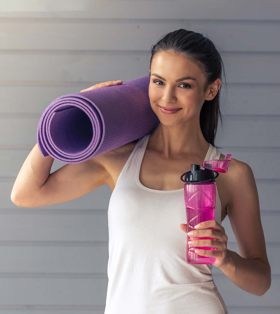 Smiling woman going to yoga class