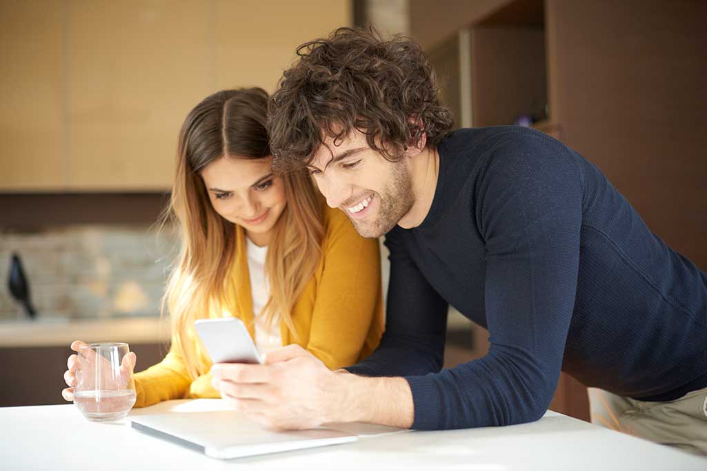 Couple looking at mobile phone