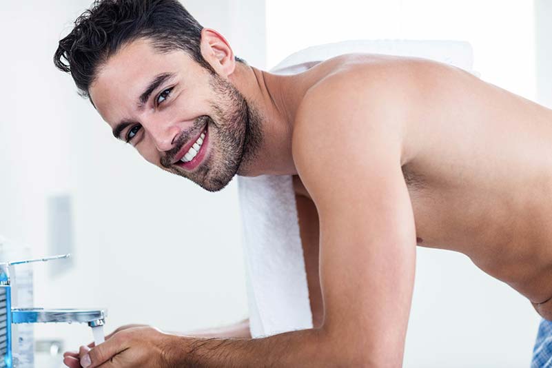 Smiling man washing up 