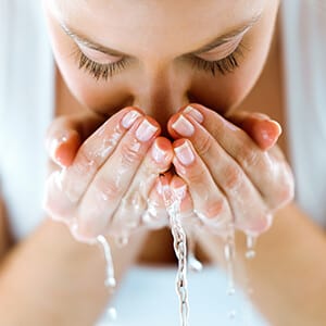 Woman washing her face